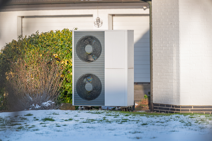 Technician installing an air-source heat pump